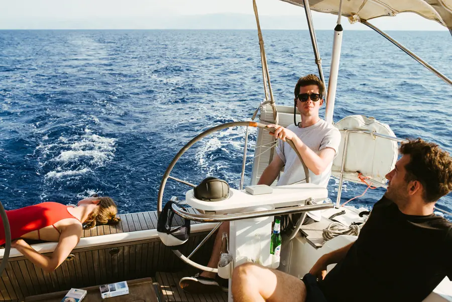 Friends sailing together at the helm