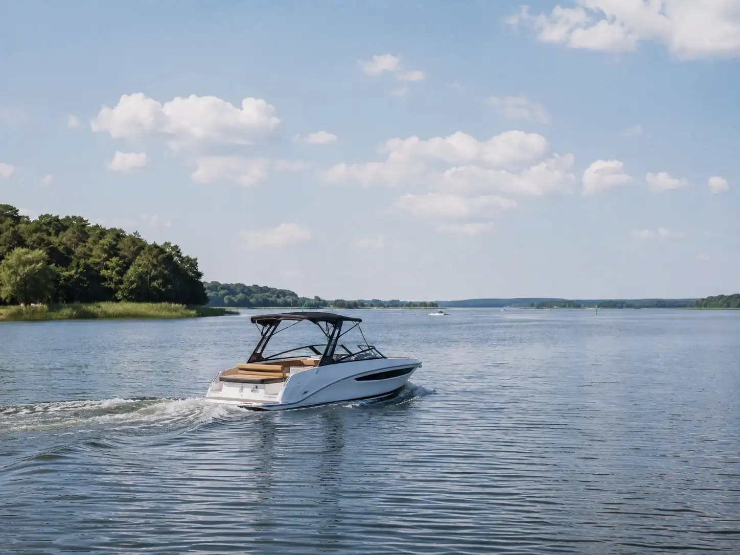Small motor boat crossing broad sheltered water